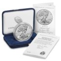 a silver coin in a box and a certificate