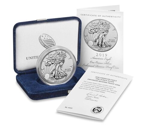 a silver coin in a box and a certificate