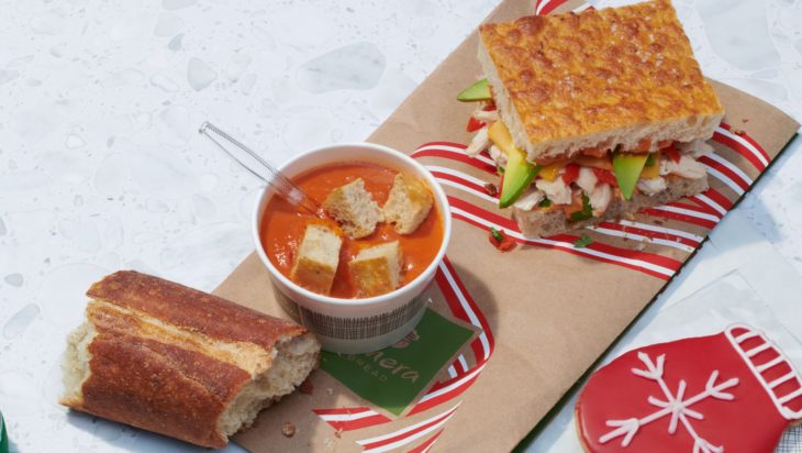 a sandwich and soup on a paper tray