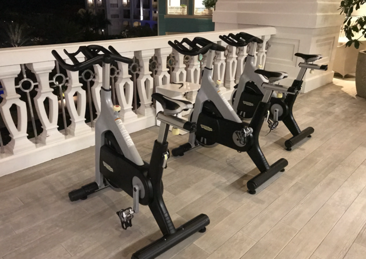 a group of exercise bikes on a wood floor