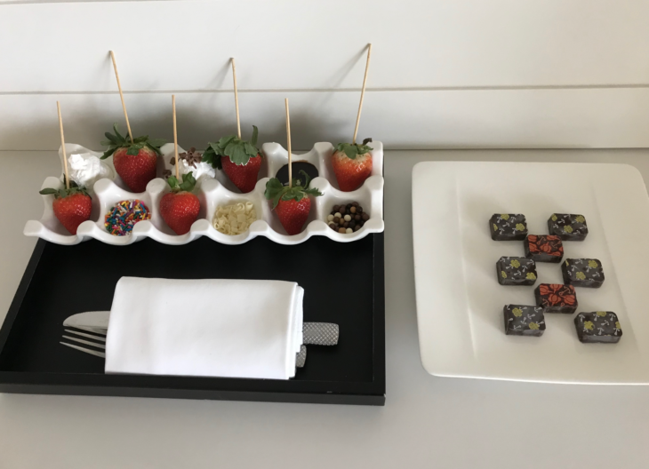 a tray of strawberries and chocolates