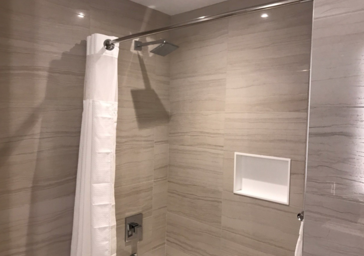 a shower with a white towel