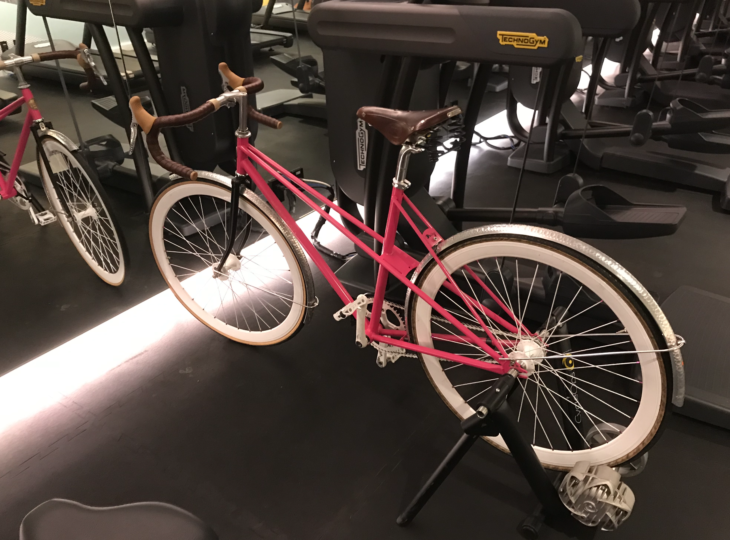 a pink bicycle on a stand