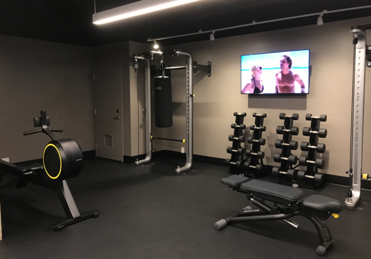 a gym with weights and a tv