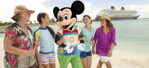 a group of women walking on a beach with a person in a mickey mouse garment