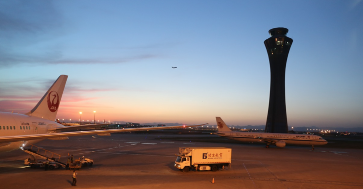 an airport with a tower and planes