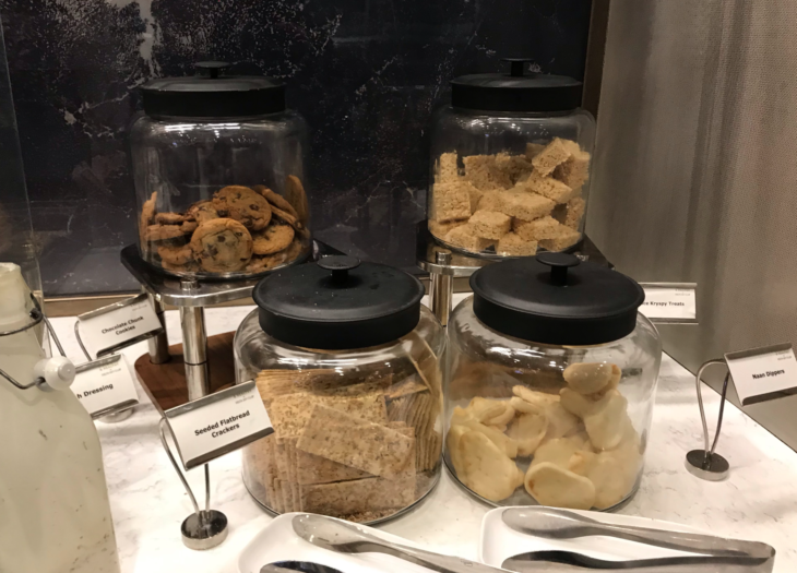 a group of glass jars with food in them