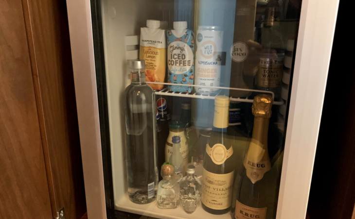 a refrigerator with bottles of alcohol and other beverages
