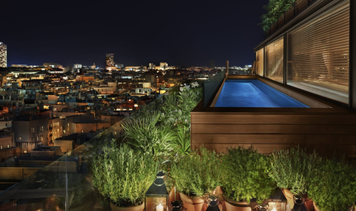 a pool on a rooftop overlooking a city