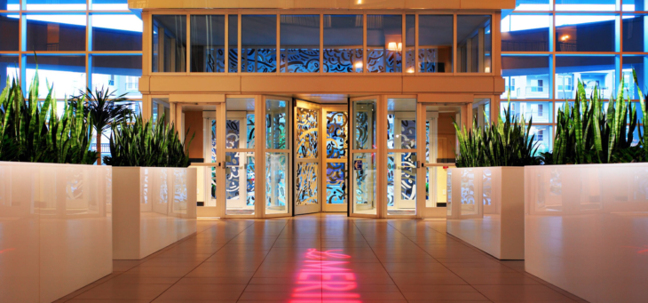 a building with glass doors and plants