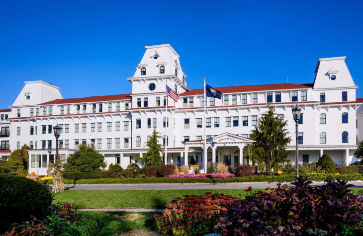 a large white building with a flag on the front