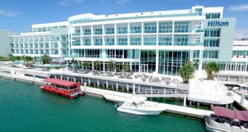 a large white building with a boat in the water