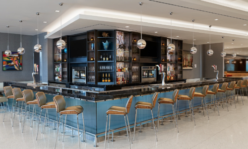 a bar with chairs and a counter