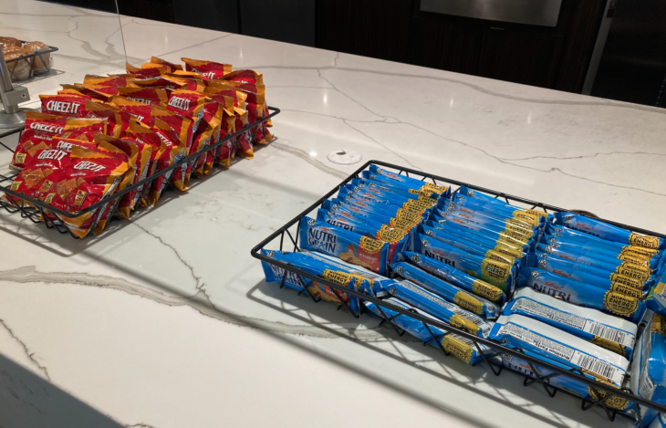 a group of blue and orange packages of candy on a marble counter