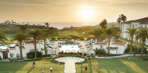 a group of people playing frisbee in a resort