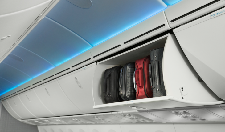 luggage in a shelf on an airplane