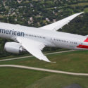 an airplane flying over a field