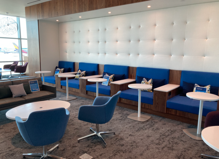 a room with blue and white chairs and tables