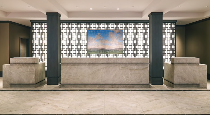 a marble reception desk in a lobby