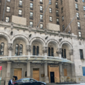 a man standing in front of a building