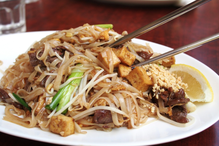 a plate of food with chopsticks