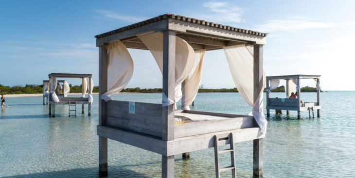 a wooden bed on stilts in water