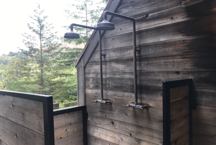 a shower heads on a wooden wall