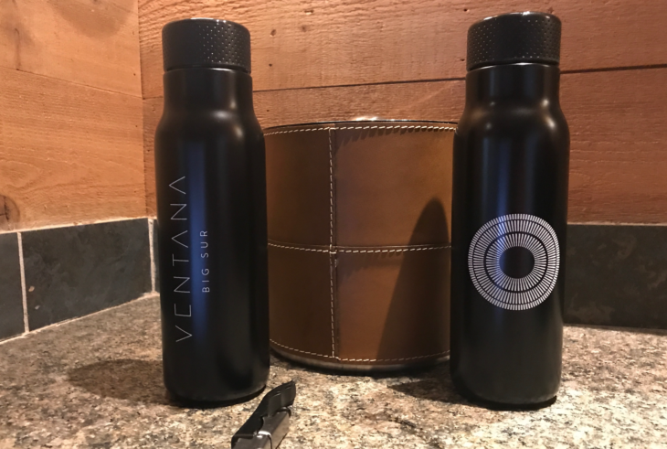 two black bottles on a counter