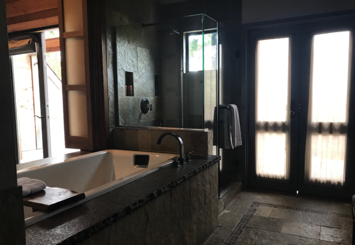 a bathroom with a glass shower and a bathtub