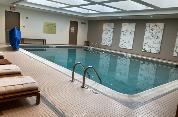 a swimming pool with a bench and a chair