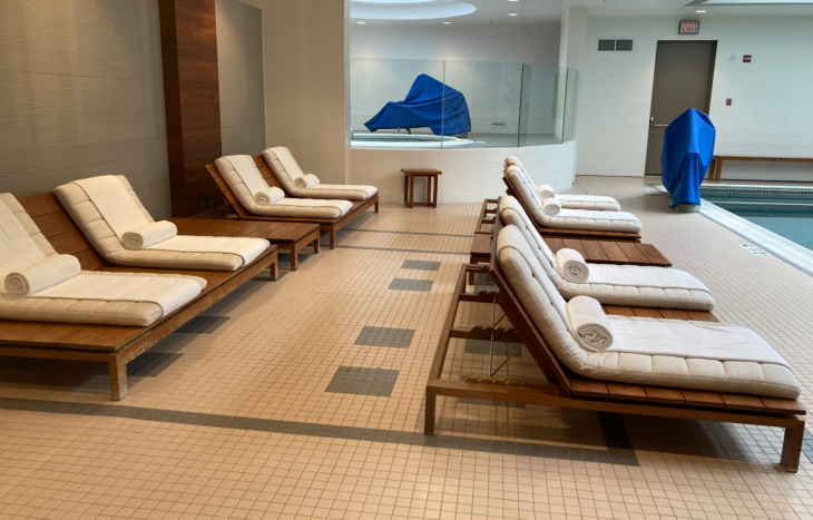 a room with lounge chairs and a blue cover