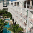 a pool and a building with balconies