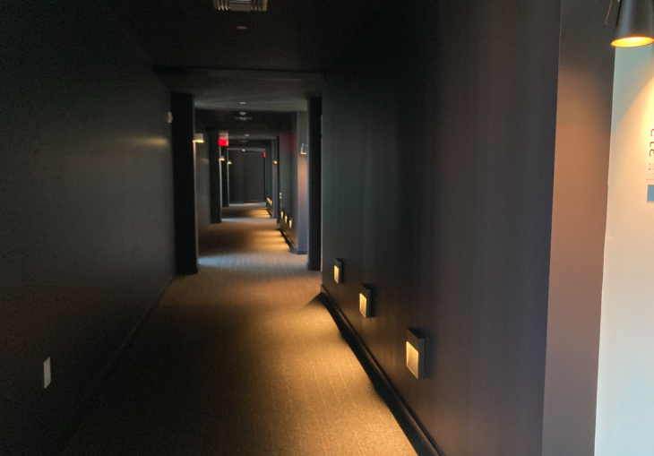 a hallway with lights on the wall