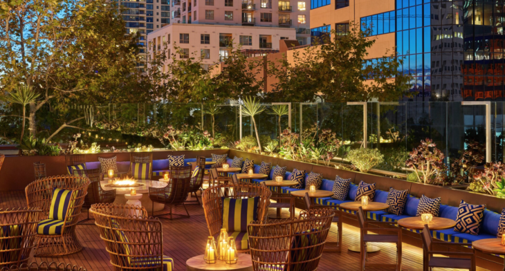 a patio with chairs and tables and candles on it