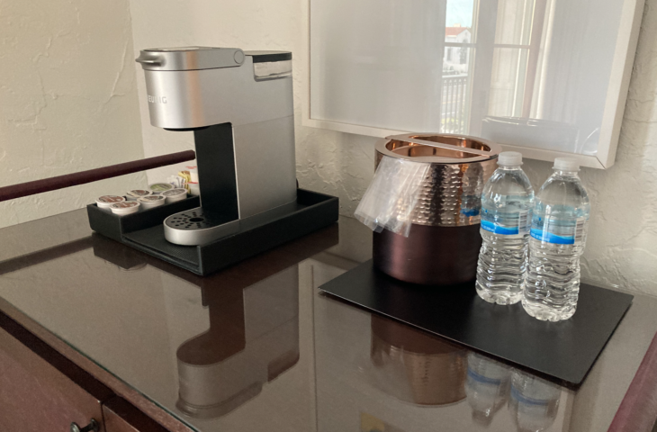 a coffee machine and water bottles on a table