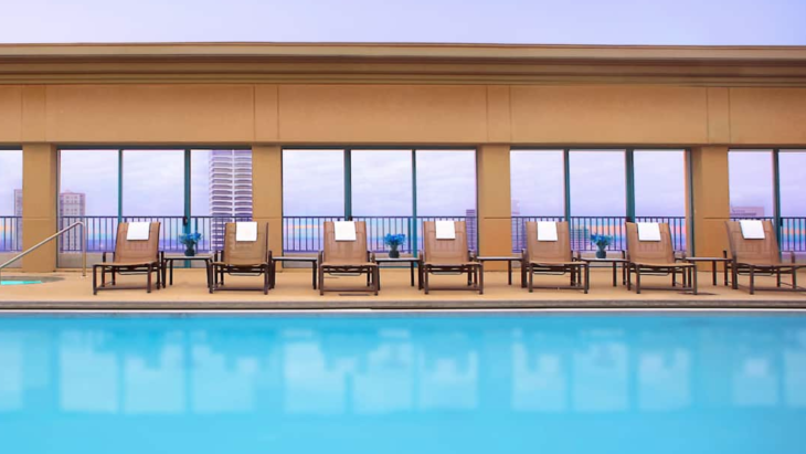 a pool with chairs and a deck chair