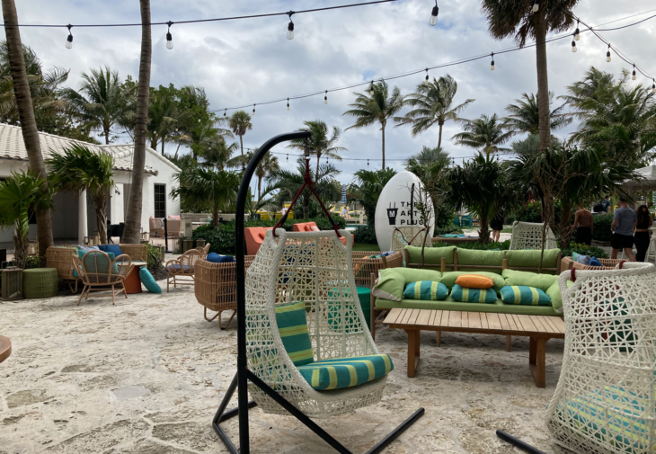 a chair and table with pillows on it