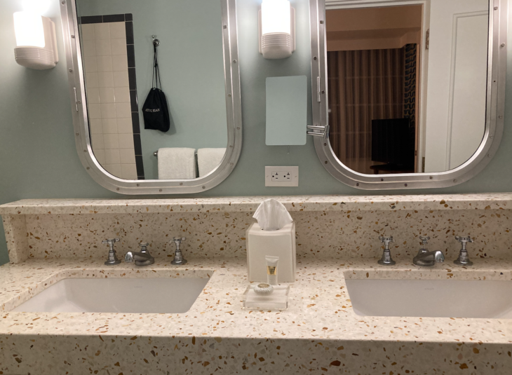 a bathroom with two sinks and a mirror