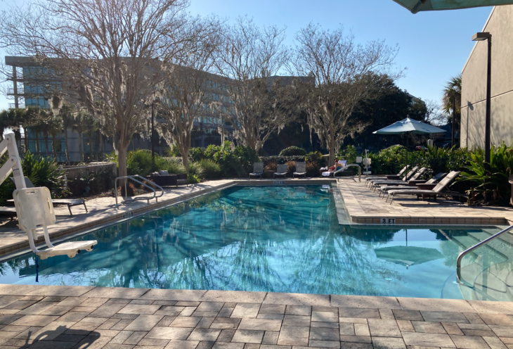 a pool with chairs and umbrellas