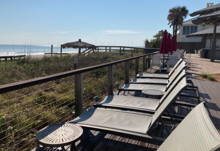 a row of chairs on a deck