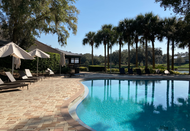 a pool with umbrellas and chairs