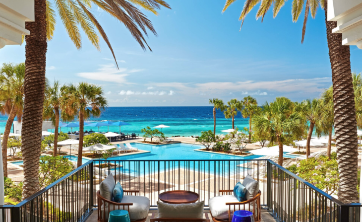 a pool with palm trees and chairs