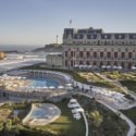 a large building with a pool and a large building with a large tower