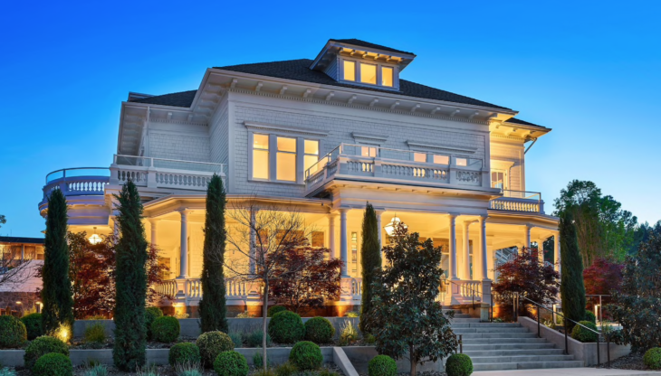 a large white house with a large porch and stairs