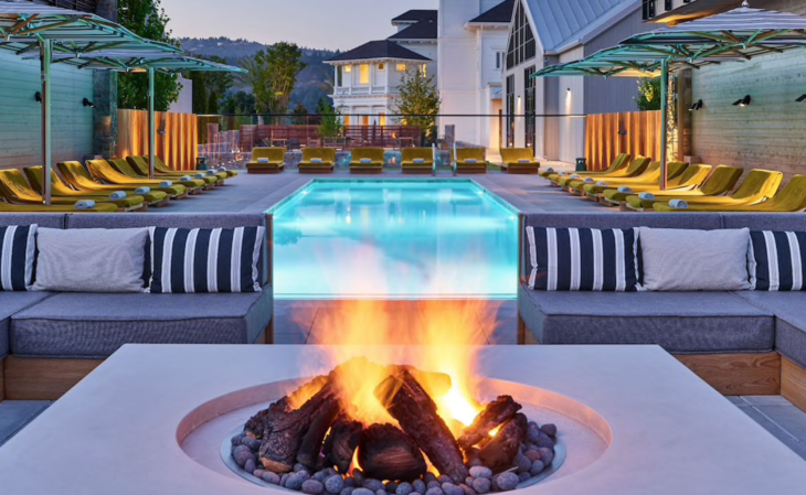 a fire pit with a pool in the background