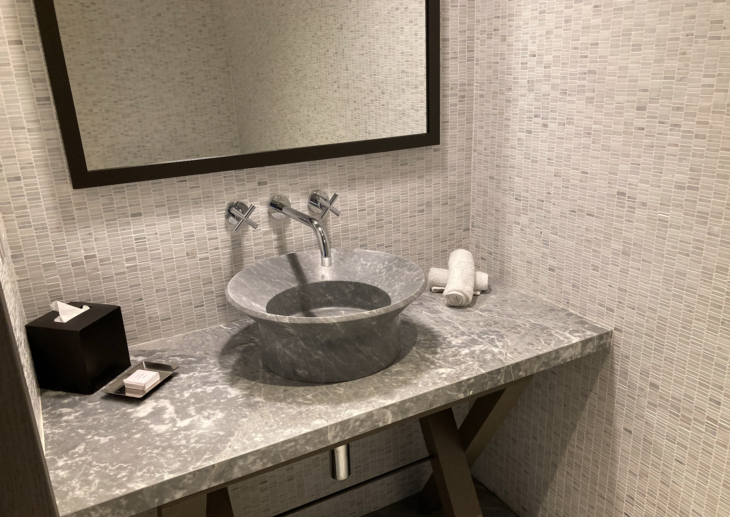 a sink with a mirror and a towel on the counter