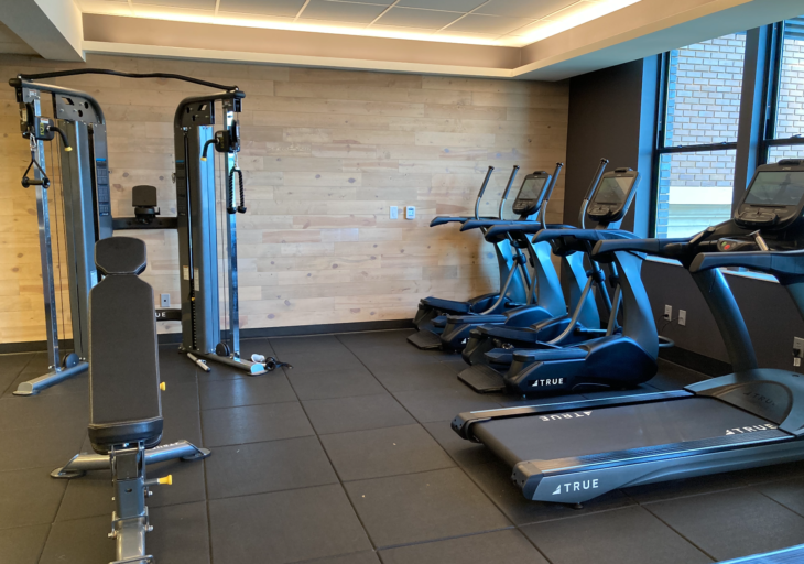 a room with exercise machines and treadmills