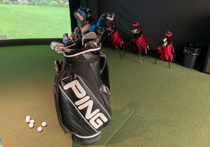 a golf bag with golf clubs and balls