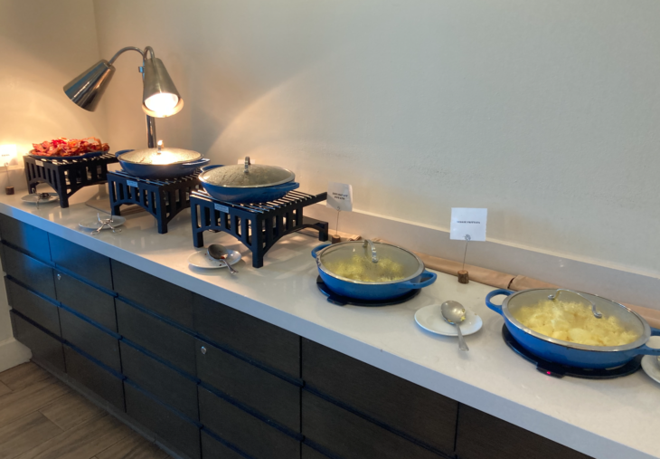 a row of bowls with food on a counter