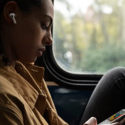 a woman looking at her phone while sitting in a bus